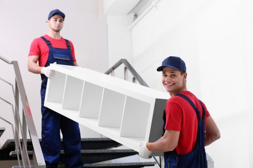 Trained staff using safe lifting techniques on a moving job