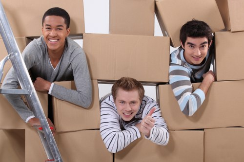 Moving team handling furniture and boxes in a Primrose Hill apartment building