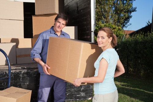 Professional movers loading household items into a removal van