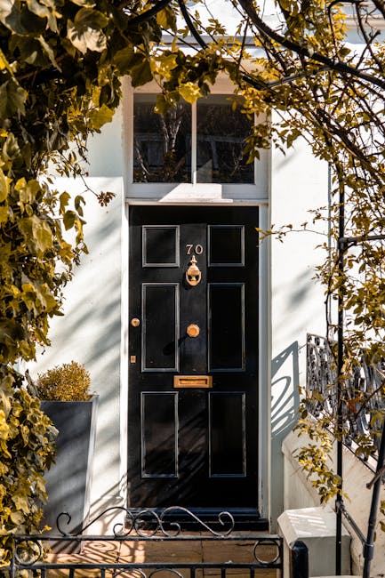 Exterior view of a retail shop named 'Retro Clothing' with a black storefront and a yellow sign, located on the ground floor of a multi-story brick building in Primrose Hill. The shop window displays 